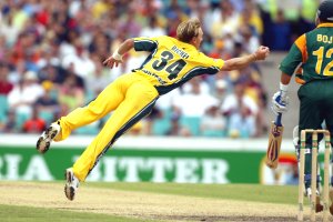 Andy Bichel of Australia dives to take a caught and bowled